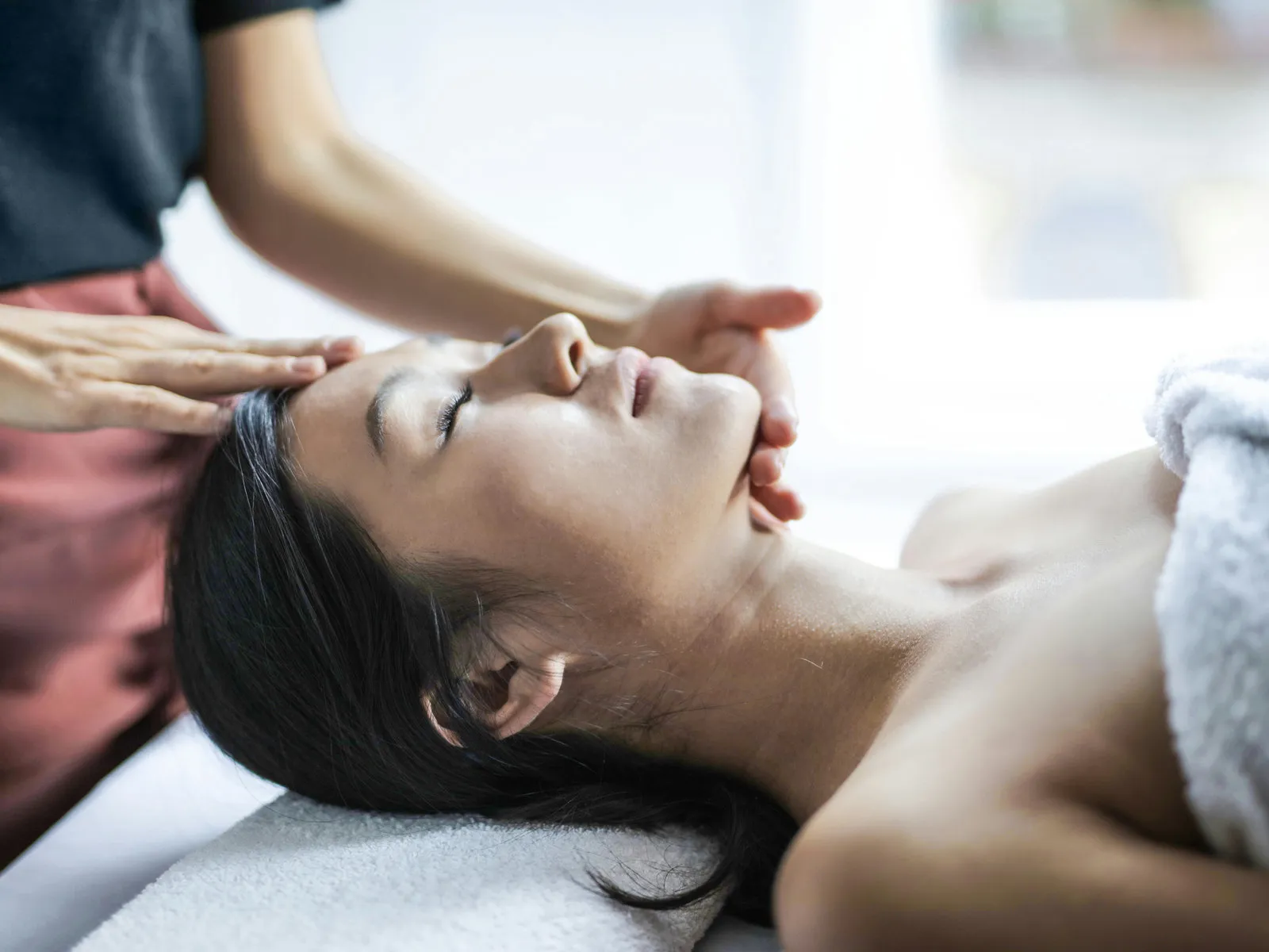 Relaxing head and face massage wrapped in a warm towel during a Forest Spa head spa session