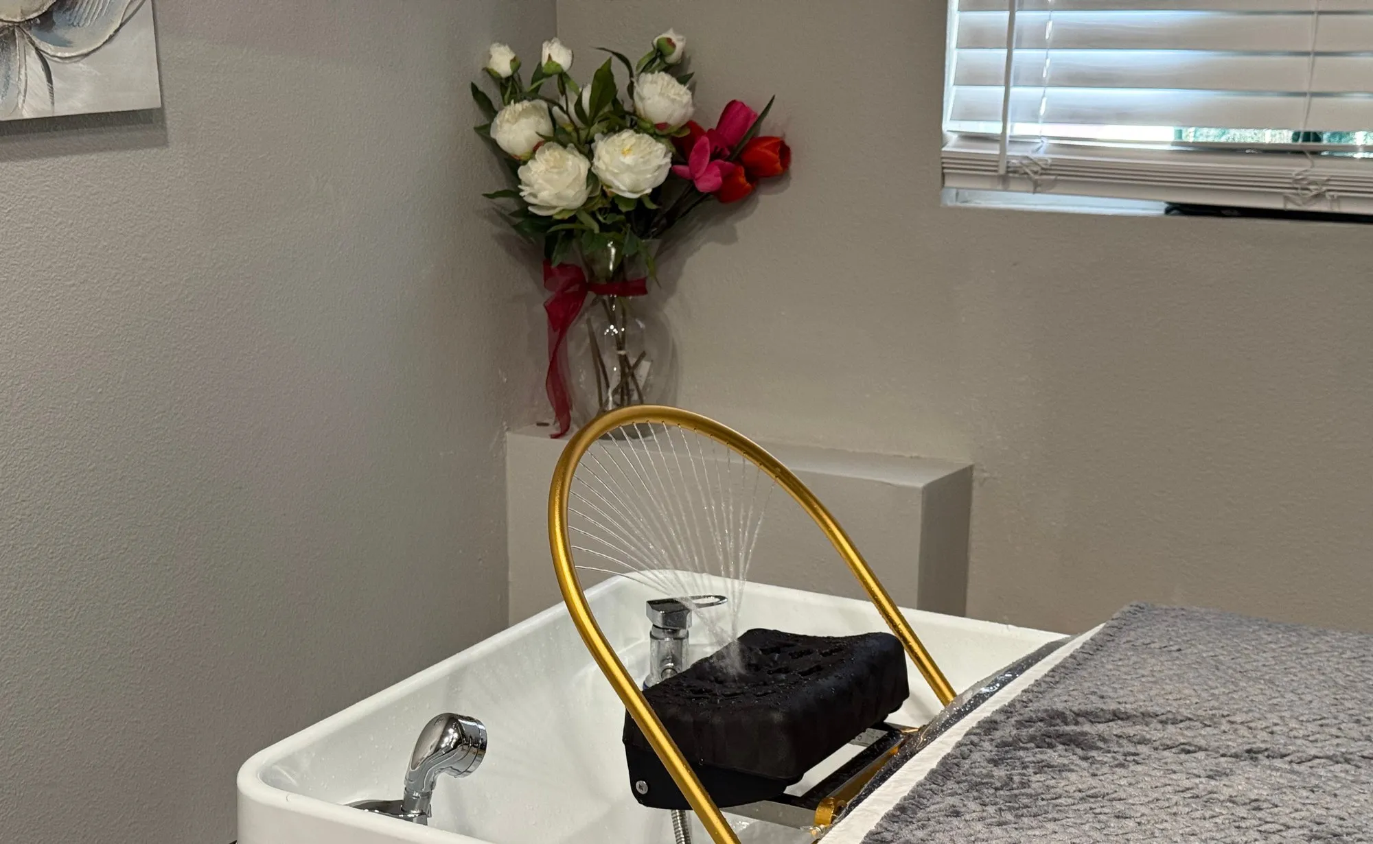 Forest Spa head spa station in Poway with a gold waterfall basin and fresh flowers